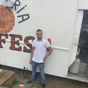 a man standing in front of a food truck