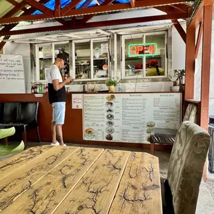 a woman standing in a taqueria