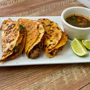 A delicious order of quesabirria tacos with a  side of consume soup!
