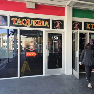 a woman walking in front of a store