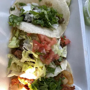 two tacos in a styrofoam container
