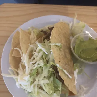 Crispy taco $4, it comes with sour cream and guacamole.