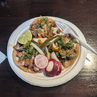 From left, clockwise: carnitas, al pastor, asada