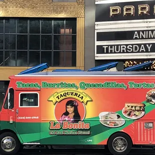 a food truck parked in front of a theater