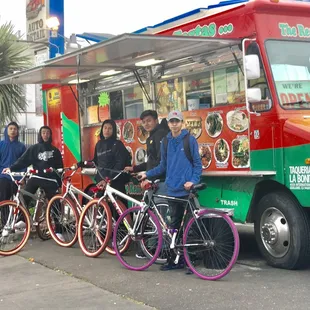 a group of people standing in front of a food truck
