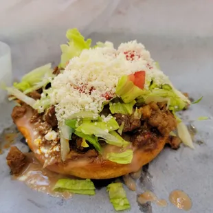 a taqueria la calenta with cheese and lettuce