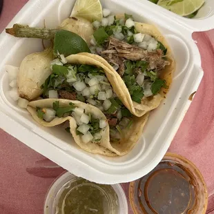 two tacos in a styrofoam container