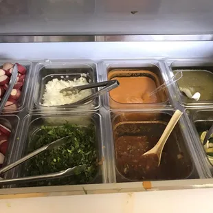 You are given plain tacos, and you put all of the toppings on yourself at the salsa bar. This includes salsa, onions, cilantro, and limes.