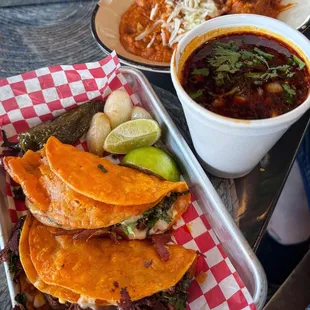 Birria tacos with refried beans (top) and a cup of hot fresh consommé for dipping.