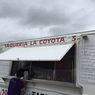  a man ordering food from a food truck