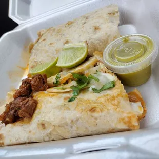 a burrito in a styrofoam container