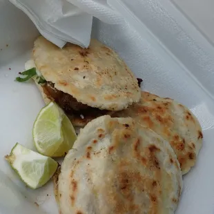 a close up of a taqueria in a styrofoam container