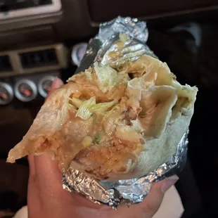 a hand holding a burrito