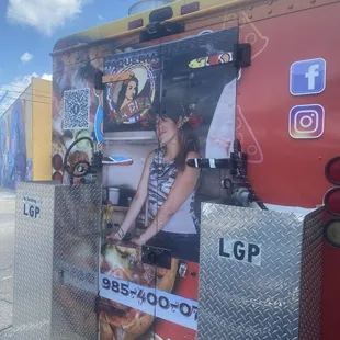 Back of the food truck with pic of main cook.