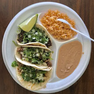 Beef, goat and pork tacos with rice and beans