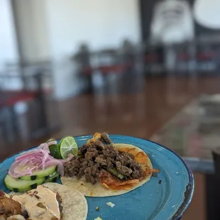 Pork Belly taco with chipotle crema and Taco Chingon (Carne asada, roasted green chile, with a crispy cheese layer)