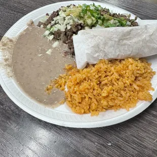 Carne asada taco with rice and beans.