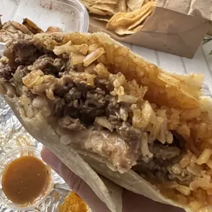 Asada burrito with everything (asada, refried beans, rice, onion, cilantro)