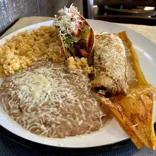Combination plate with crispy chicken taco and pork tamale