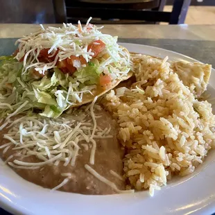 Combination plate with chicken tostada, chicken enchilada, rice and beans - Tasty!