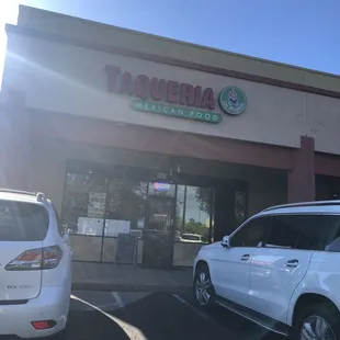 cars parked in front of a taqueria