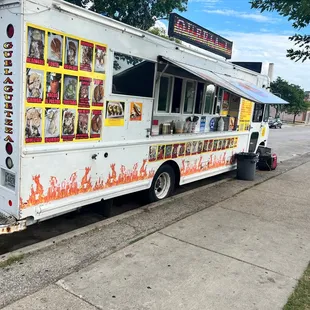a taqueria truck parked on the side of the road