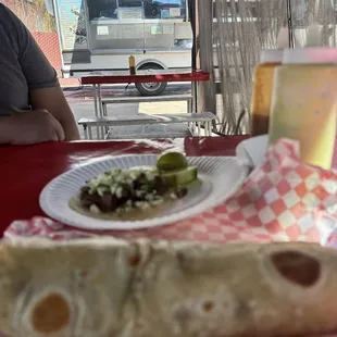 a taqueria sandwich on a paper plate