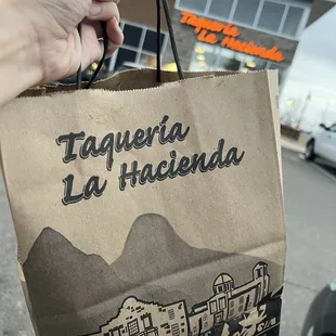 a hand holding a bag