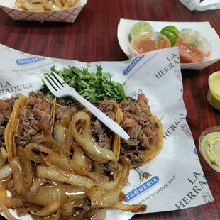 The double corn with mixed bistec and extra crispy tripa. Sauteed onions and cilantro on the side.