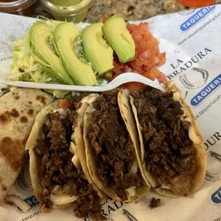 Bistec maiz tacos w/ avocado and queso.