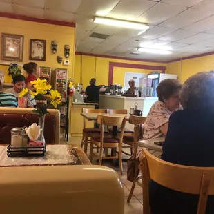people sitting at tables in a restaurant