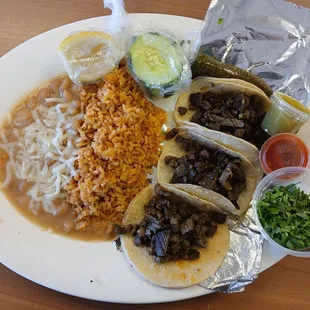 3 steak tacos, rice, and beans.