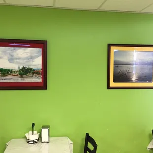 a table and two framed pictures
