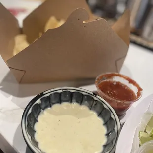 Side of chips and queso with salsa