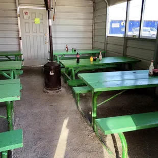 a green table and benches