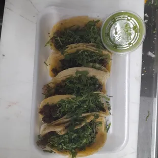 three tacos on a white plate