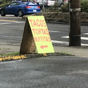 a taqueria sign on the corner of a street
