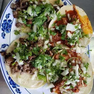 Asada tacos and birria tacos with onions and cilantro. Our tortillas are hand made!