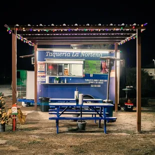 a blue food truck at night