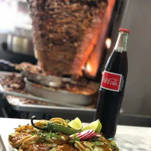 a plate of tacos and a bottle of coke