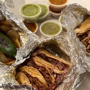two sandwiches wrapped in foil