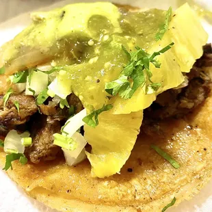 Al pastor with piña (added green salsa and guacamole, chopped onion and cilantro, sautéed onions)