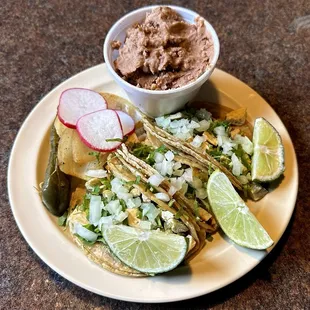 Three Pollo (Chicken) Tacos with a Side of Beans and Toppings from the Toppings Bar