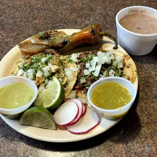 Two Tacos (Pollo and Al Pastor) with a Side of Beans, Complimentary Toppings and Extras, with Two Salsas (Avocado and Medium)