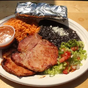 Chuletas Dish - (Porkchops): Rice and Beans, Tortillas, and salad.