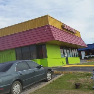 a car parked in front of a taqueria