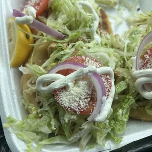 a taqueria with lettuce, tomatoes, onions, and cheese