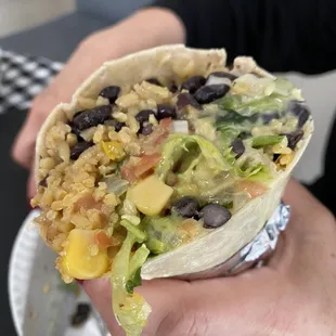 a person holding a burrito