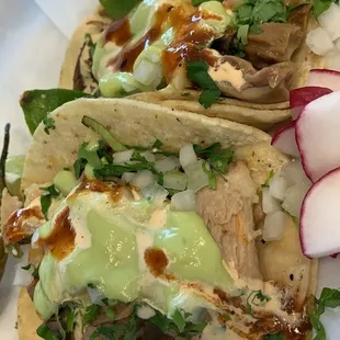 two tacos with meat and vegetables
