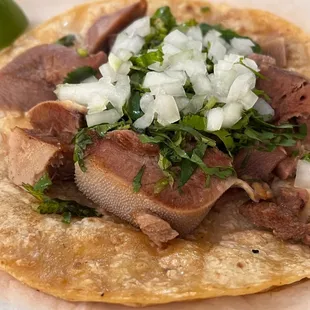  a taco with meat, onions, and cilantro
